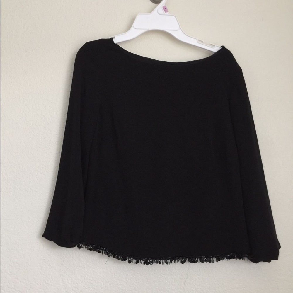Black shirt with sequins at the bottom.